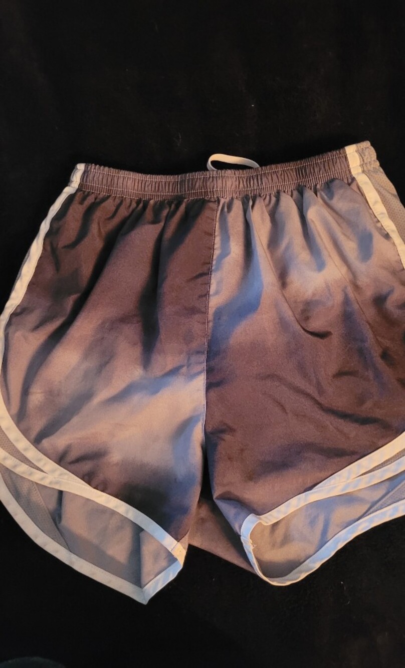 Nike Women's Gray Athletic Shorts with White Trim.